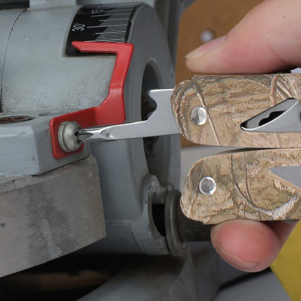 Multi-tool screwdriver bit turning a screw on a workshop machine