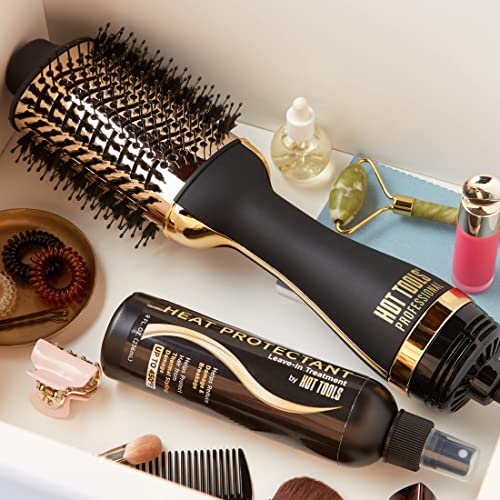 Gold and black hot air brush in a vanity drawer with heat protectant spray