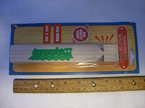 Carded wooden train whistle lying flat above a ruler, about 7 inches long