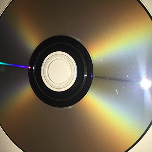 Close-up of the underside of a game disc reflecting rainbow light