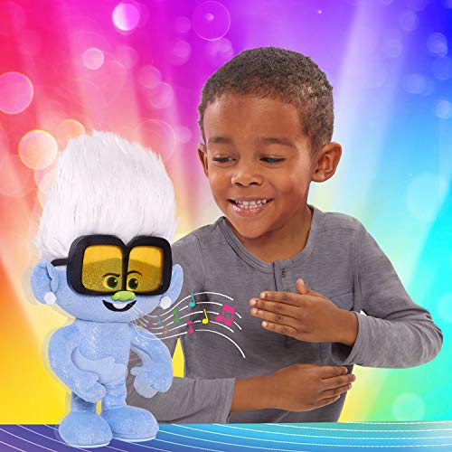 Smiling boy dancing next to the Tiny Diamond plush as it plays music