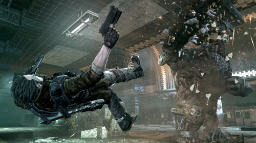 Hero diving backward firing at a rock monster in a subway