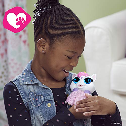Smiling girl cuddling the FurReal Airina unicorn toy