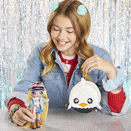 Smiling girl holding the eagle purse next to the Erika Featherton doll