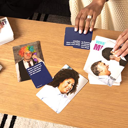 Players laying meme photo cards and caption cards on a wooden table