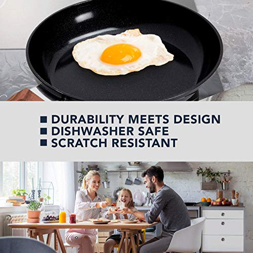 Fried egg in a black pan above a family eating breakfast at a table