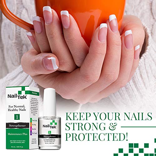 Hands with French manicure around an orange mug beside the Nail Tek bottle