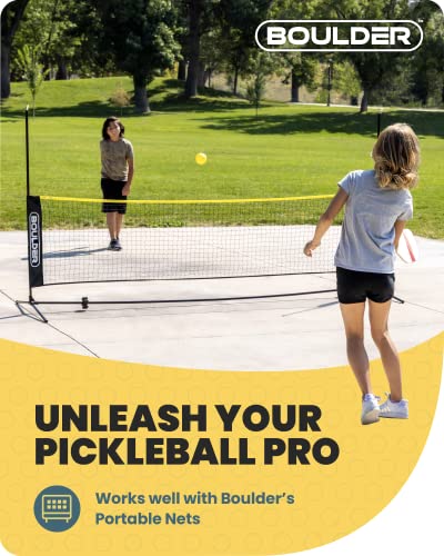 Two girls playing pickleball over a portable net in a park