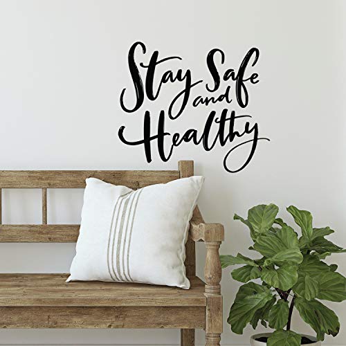 Black script Stay Safe and Healthy wall decal above a wooden bench and pillow