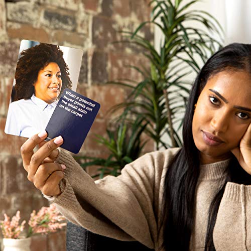 Woman holding up a photo card and a caption about a small stain on the carpet