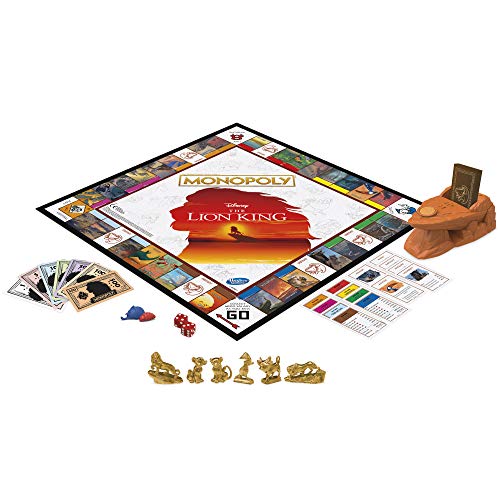 Monopoly The Lion King board laid out with cards, money, dice and gold tokens