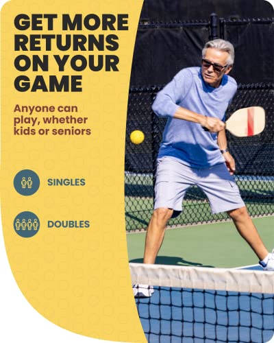 Older man hitting a ball with a wooden paddle at the net