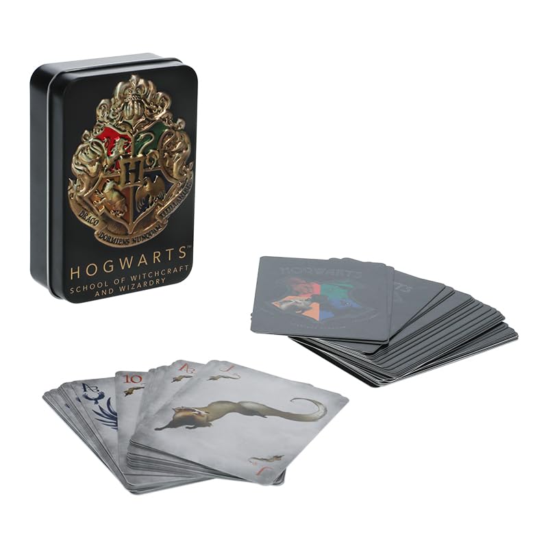 Black crest tin beside a fanned stack of grey playing cards