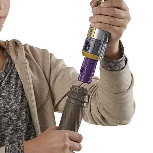 Child fitting a purple lightsaber hilt into the staff end