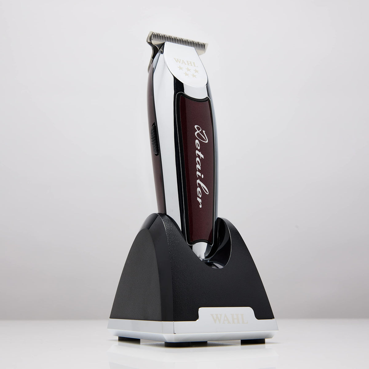 Detailer trimmer standing in its black charging base with chrome trim
