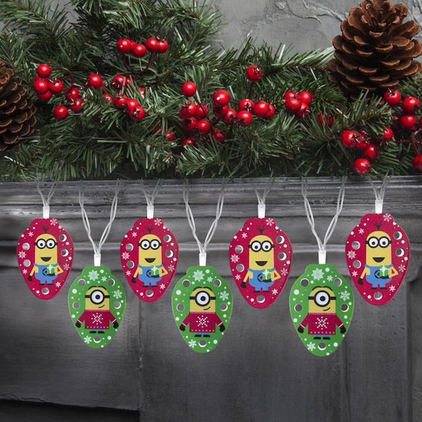 Minions Christmas string lights hung along a mantel under pine garland and berries