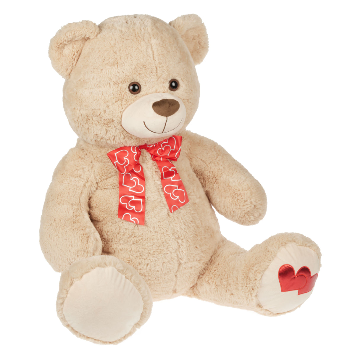 Large tan teddy bear with a red heart ribbon bow and heart patches on its feet