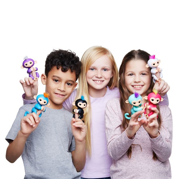 Three smiling kids with colorful Fingerlings monkeys on their fingers