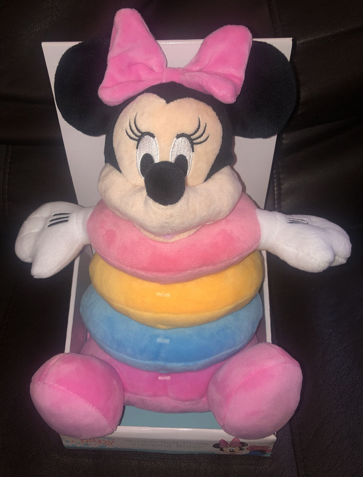 Minnie Mouse plush stacking rings toy with pink, yellow and blue rings in its box